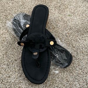 Black sandals with gold hardware
